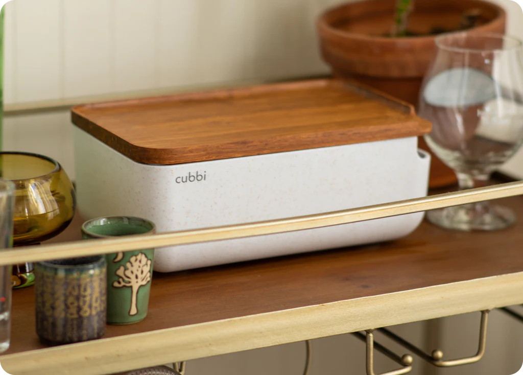 Cubbi stash box displayed on a wooden shelf, showcasing its sleek design and compact size.