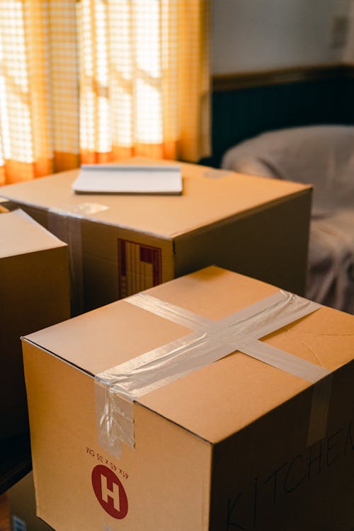 Cardboard boxes scattered on floor during relocation.