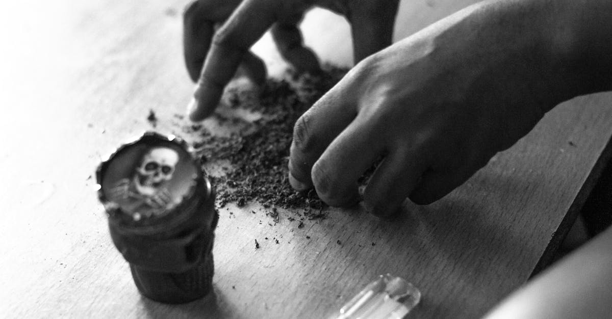 A person grabbing some powder on the table.