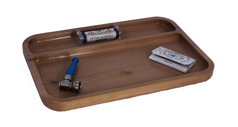 wooden tray with a pipe, rolling papers, and a rolling machine on it.