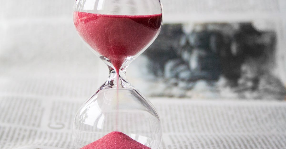 An image of an hourglass resting on top of an open book