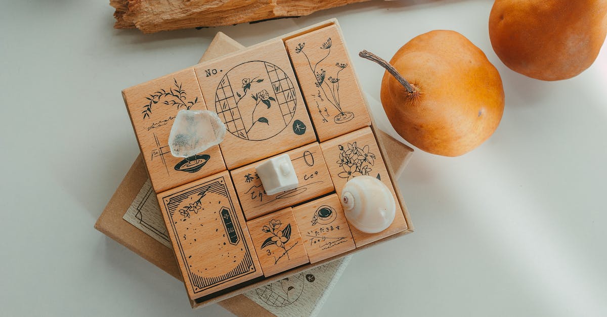 The image shows a box of wooden stamps and pears on a table.