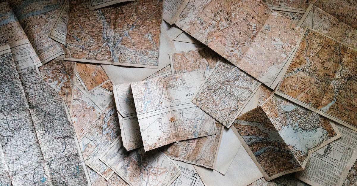 A pile of old maps laying on a table.