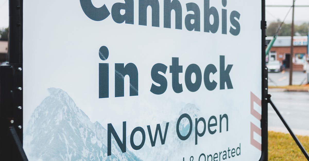 A signage with text "Cannabis in stock Now Open".